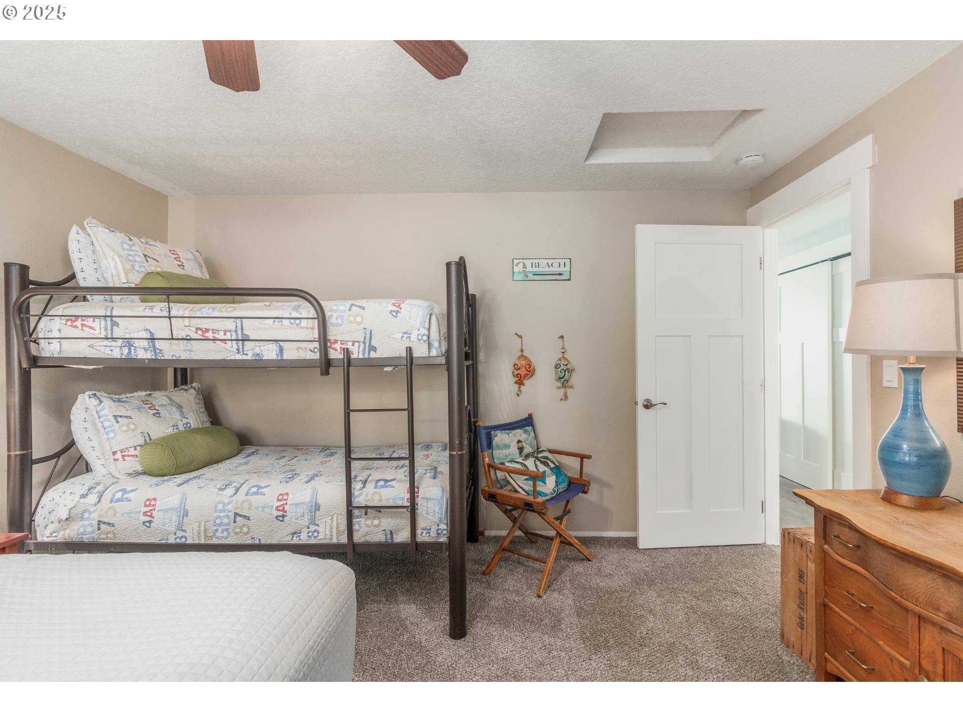 7495 Northeast Neptune Drive Lincoln City, OR 97367 - Photo 20 of 35 a bedroom with a bed and a chair