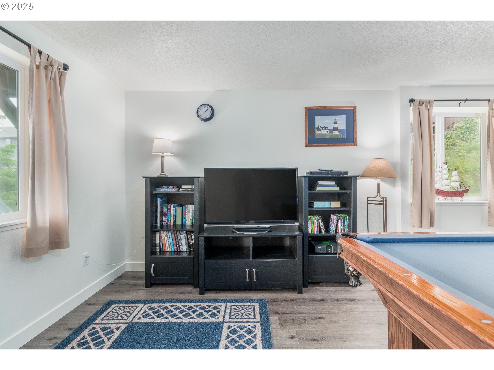 7495 Northeast Neptune Drive Lincoln City, OR 97367 - Photo 24 of 35 a living room with furniture and a flat screen tv