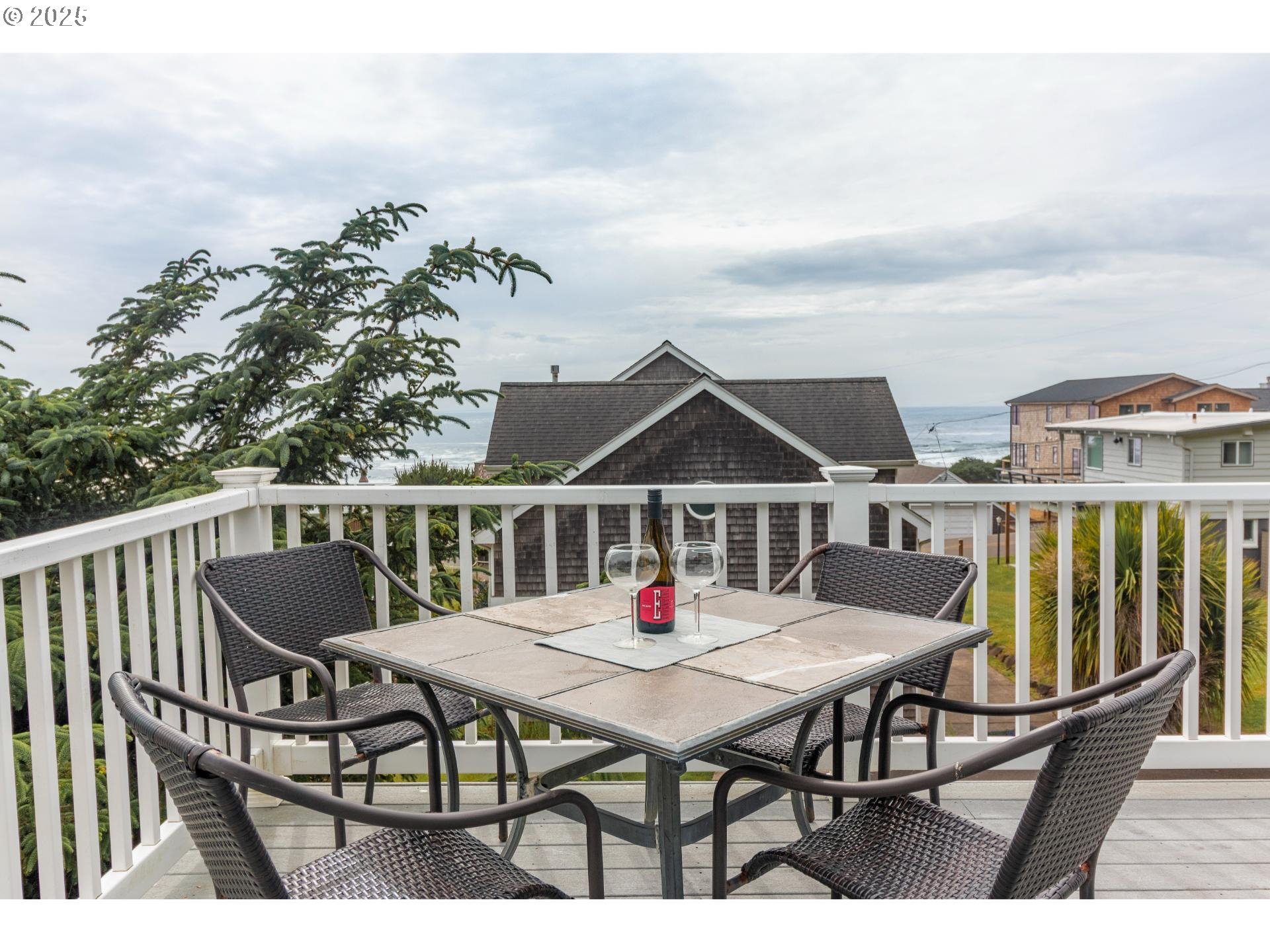 7495 Northeast Neptune Drive Lincoln City, OR 97367 - Photo 27 of 35 a roof deck with a dining table and chairs with wooden floor