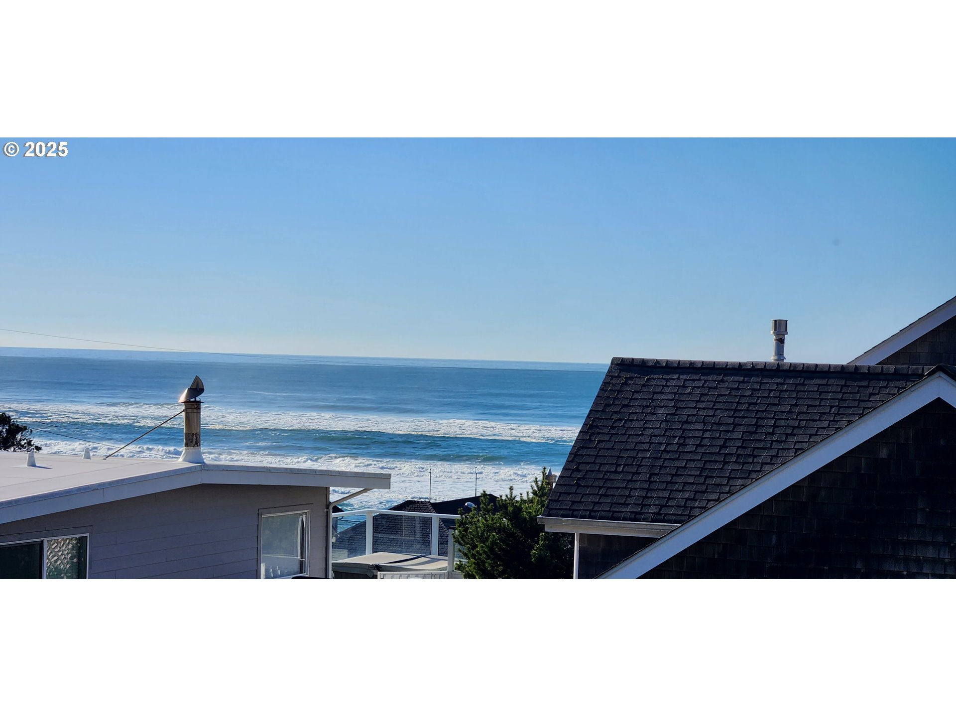 7495 Northeast Neptune Drive Lincoln City, OR 97367 - Photo 30 of 35 a picture of floor to ceiling window and an aerial view of beach