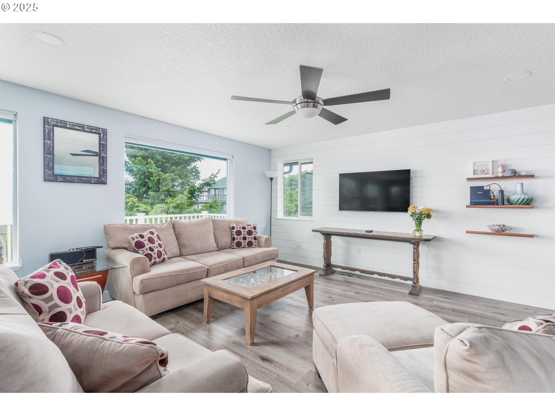 7495 Northeast Neptune Drive Lincoln City, OR 97367 - Photo 4 of 35 a living room with furniture and a flat screen tv