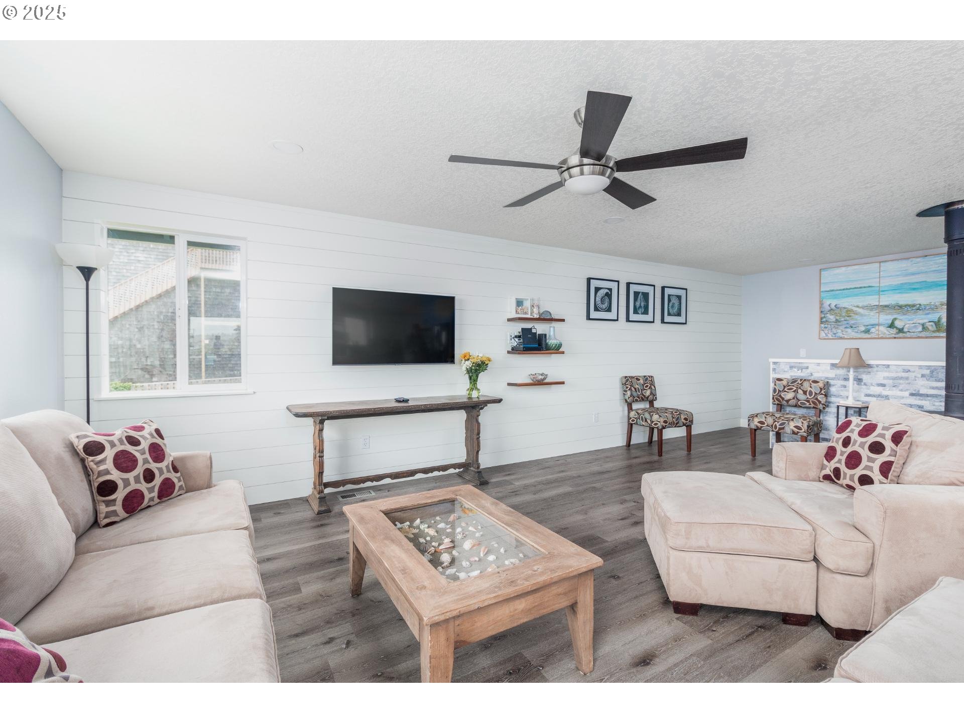 7495 Northeast Neptune Drive Lincoln City, OR 97367 - Photo 5 of 35 a living room with furniture and a flat screen tv