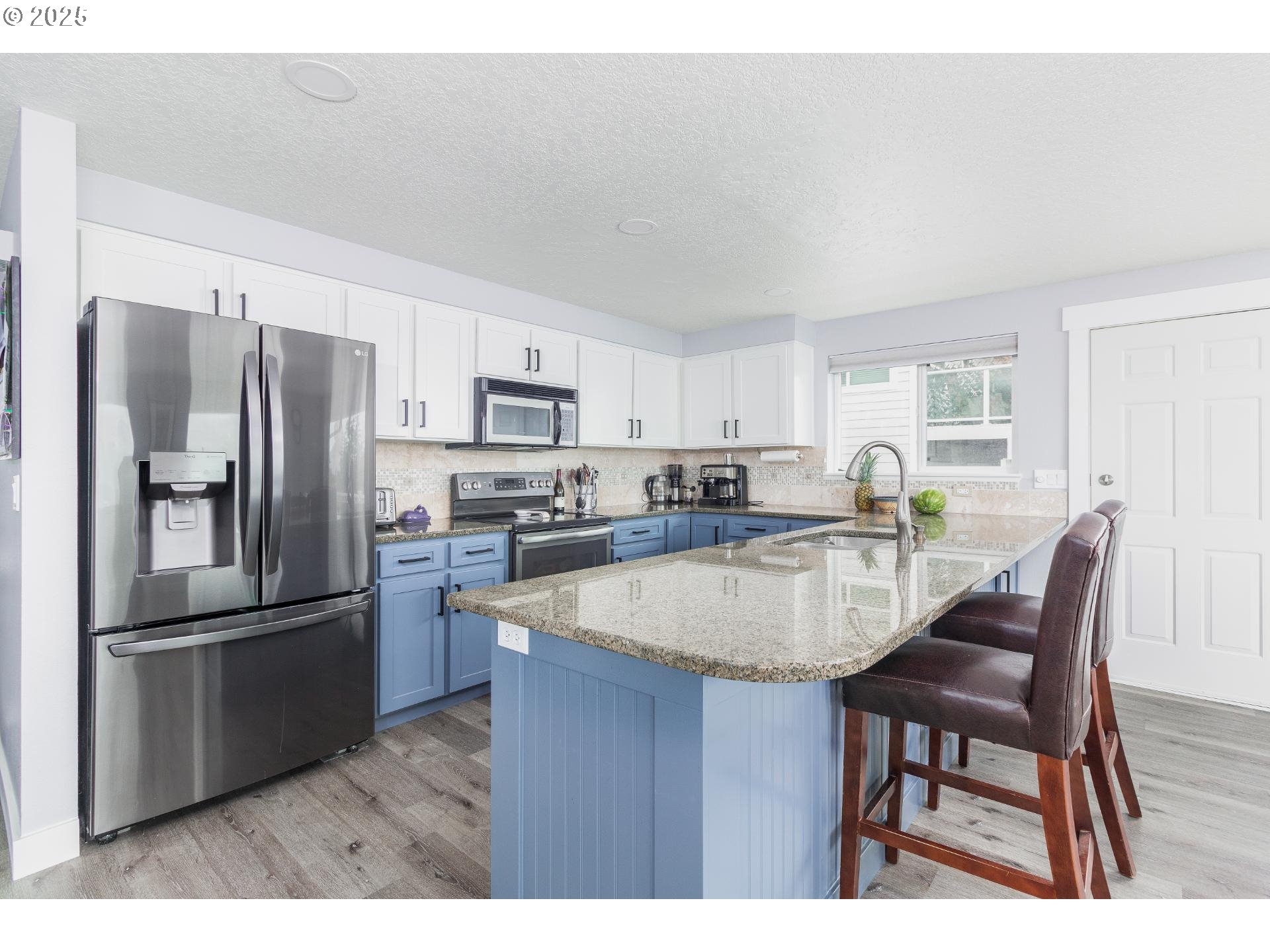 7495 Northeast Neptune Drive Lincoln City, OR 97367 - Photo 9 of 35 a kitchen with refrigerator and chairs