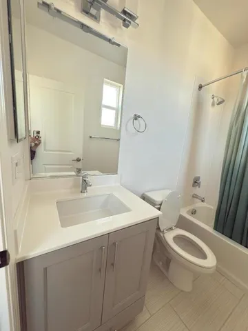 a bathroom with a sink toilet vanity and tub