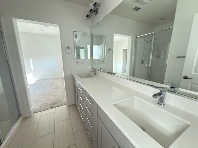 a bathroom with a tub sink and mirror