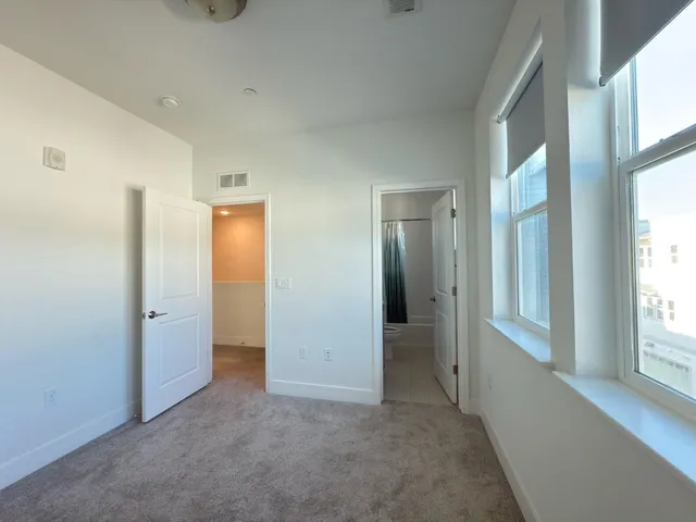 a view of an empty room with large windows