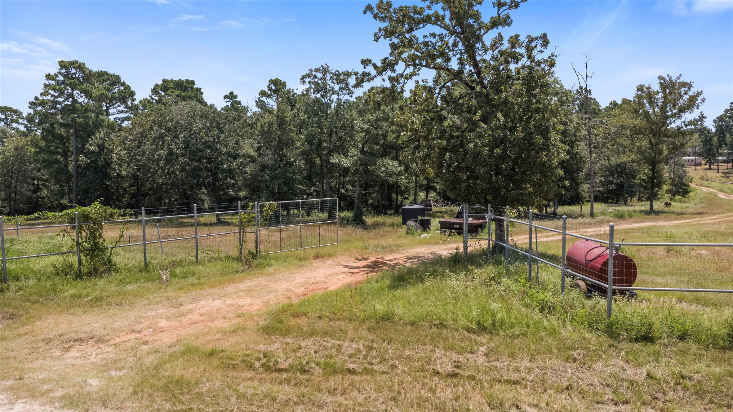 235 Flynt Road Huntsville, TX 77320 - Photo 2 of 25 a view of a swimming pool with a yard