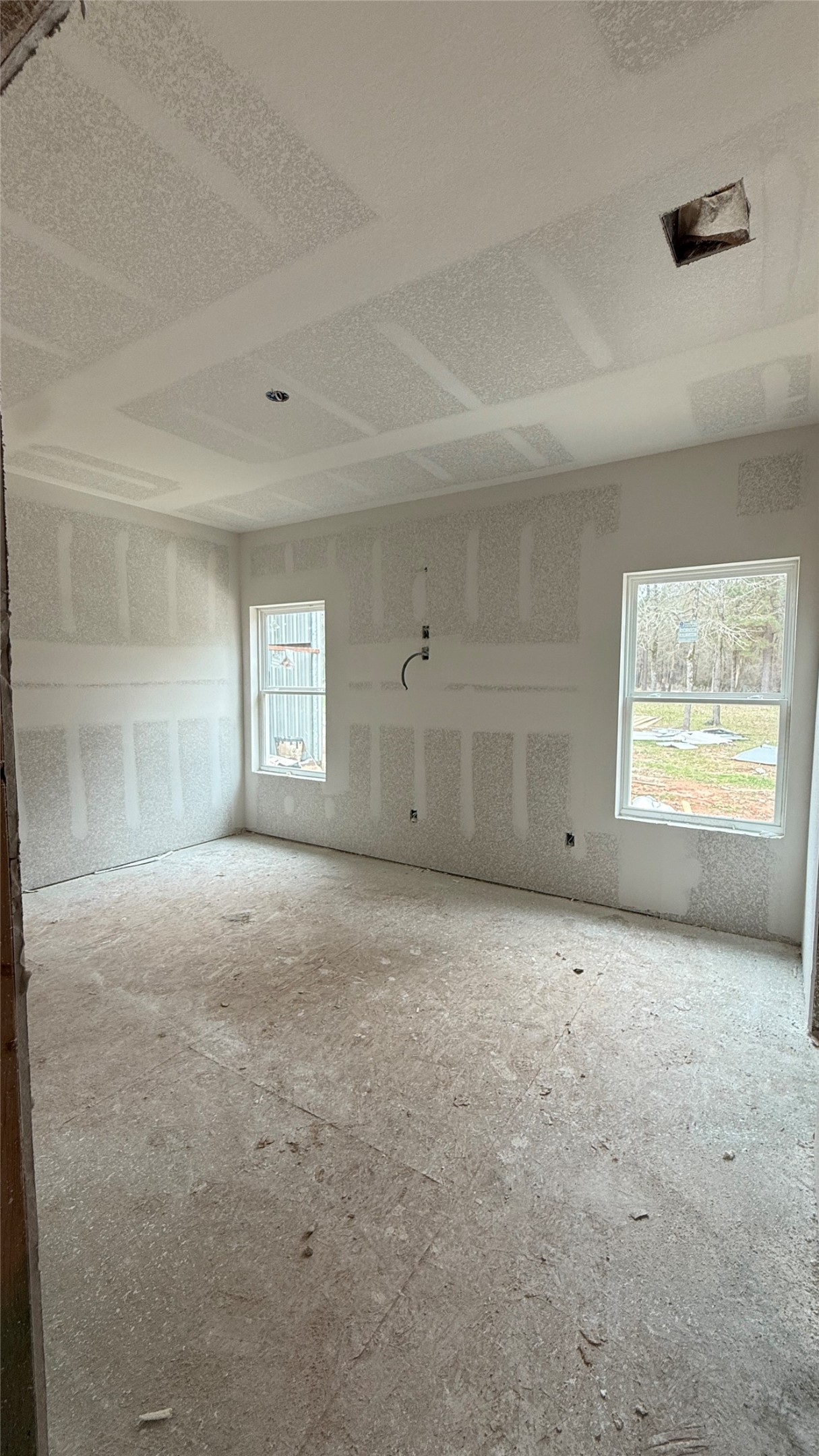 235 Flynt Road Huntsville, TX 77320 - Photo 6 of 25 a view of an empty room with a window and closet area