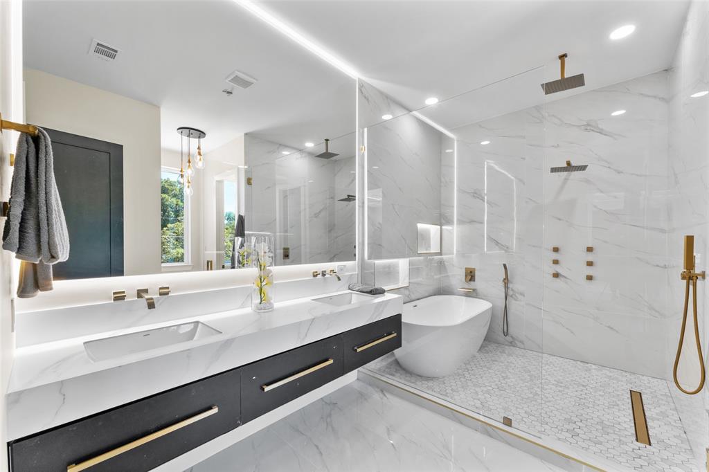 4717 Linnet Lane Dallas, TX 75209 - Photo 25 of 39 a bathroom with a double vanity sink toilet mirror and shower