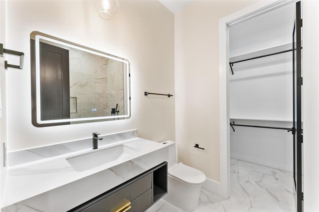 4717 Linnet Lane Dallas, TX 75209 - Photo 32 of 39 a bathroom with a sink a toilet and a mirror