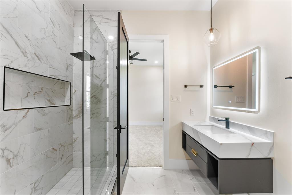 4717 Linnet Lane Dallas, TX 75209 - Photo 33 of 39 a bathroom with a sink and a mirror