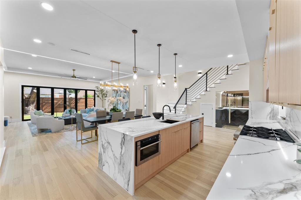 4717 Linnet Lane Dallas, TX 75209 - Photo 39 of 39 a kitchen with a sink stove and wooden cabinets