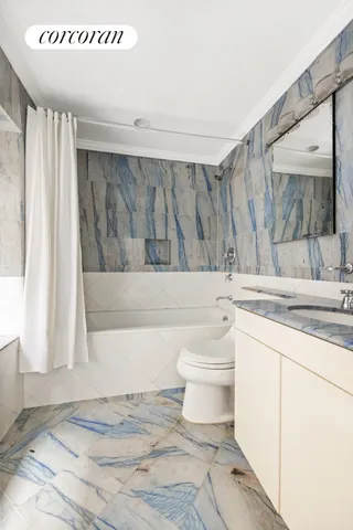 a living room with furniture large window and fireplace