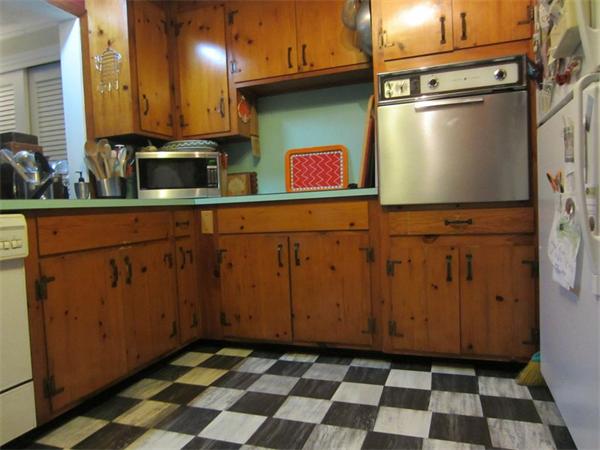 97 Sutton Road Needham, MA 02492 - Photo 7 of 11 a kitchen with stainless steel appliances granite countertop a refrigerator and a stove top oven