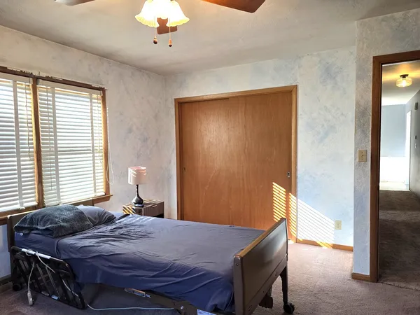 a bedroom with a bed and a chandelier