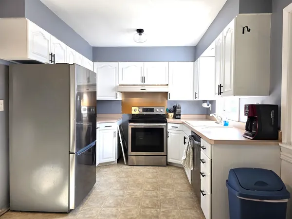 a kitchen with a stove a refrigerator and a sink