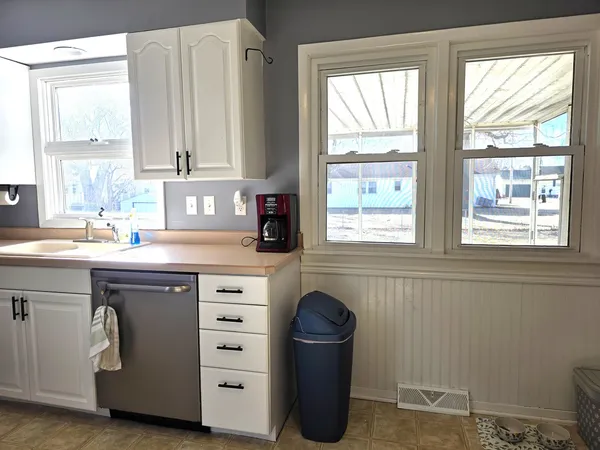 a kitchen with cabinets appliances and a window