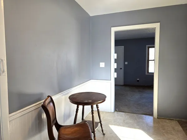 a view of kitchen with a table and a chair