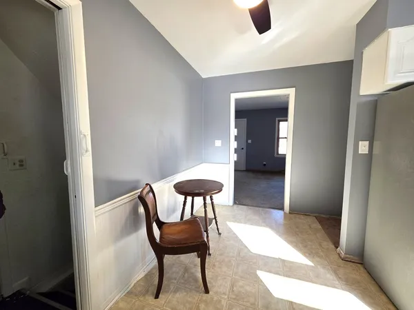 a view of a room with furniture and a window