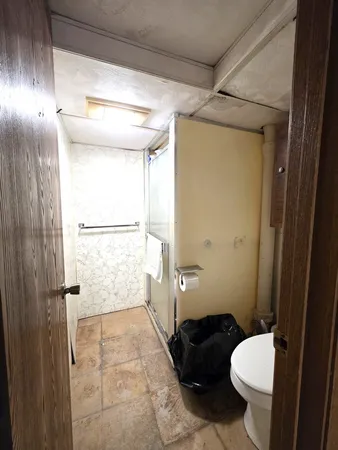 a bathroom with a toilet and a shower