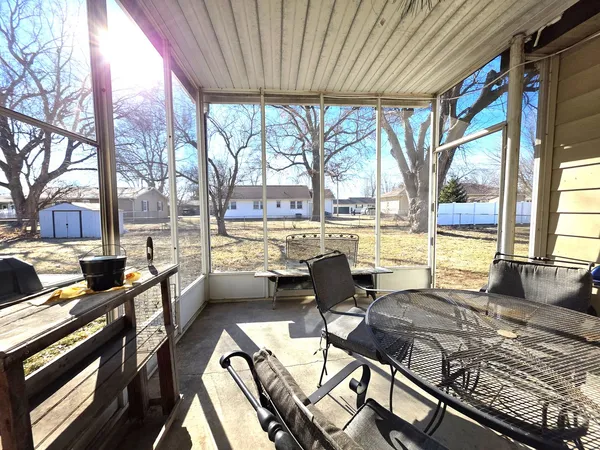 a living room with a large window and a table