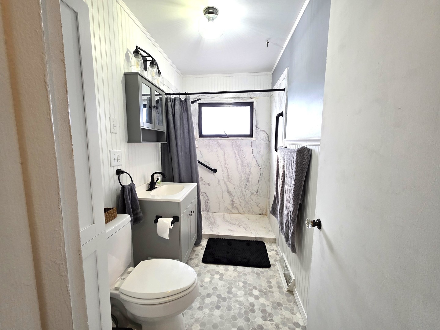 524 East Chestnut Street Geneseo, IL 61254 - Photo 8 of 39 a white toilet sitting next to a bathroom sink and a mirror