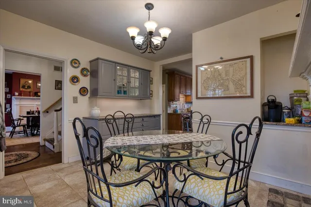 a view of a dining room with furniture and chandelier