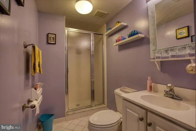 a bathroom with a sink vanity mirror and toilet
