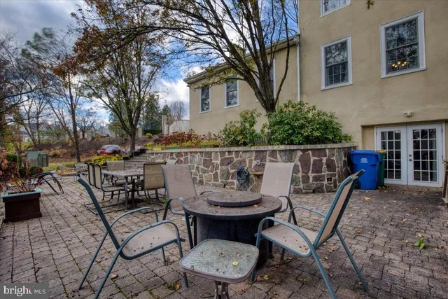 a view of a chairs and table in backyard