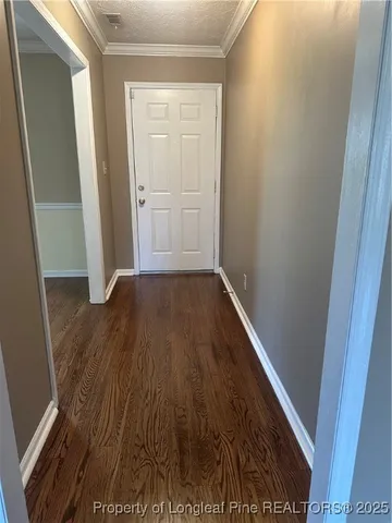 an entryway door with wooden floor
