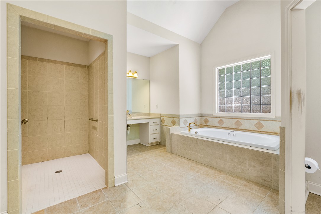 135 Sunset Bay Boulevard Seneca, SC 29672 - Photo 26 of 50 Indulge in a spacious primary bathroom featuring a generous walk-in shower, a soaking tub, and vaulted ceilings.