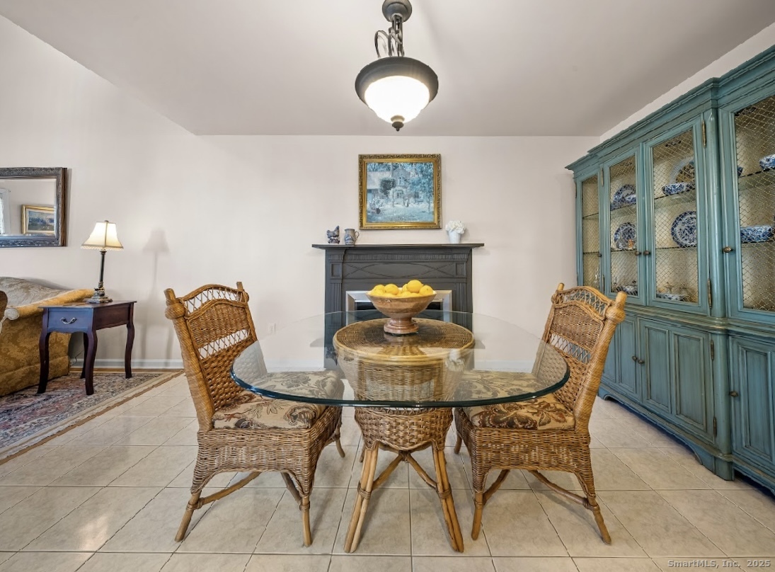 91 Forest Road, Unit B Milford, CT 06461 - Photo 11 of 28 a view of a dining room with furniture and chandelier