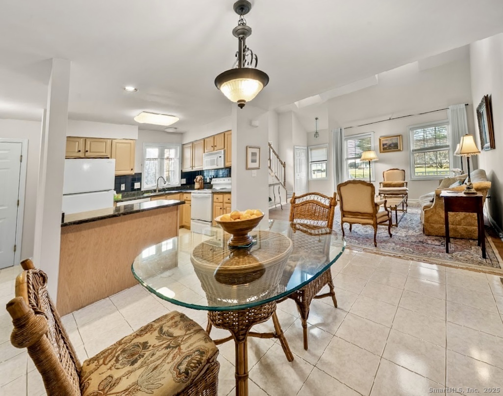 91 Forest Road, Unit B Milford, CT 06461 - Photo 13 of 28 a dining room with furniture and chandelier