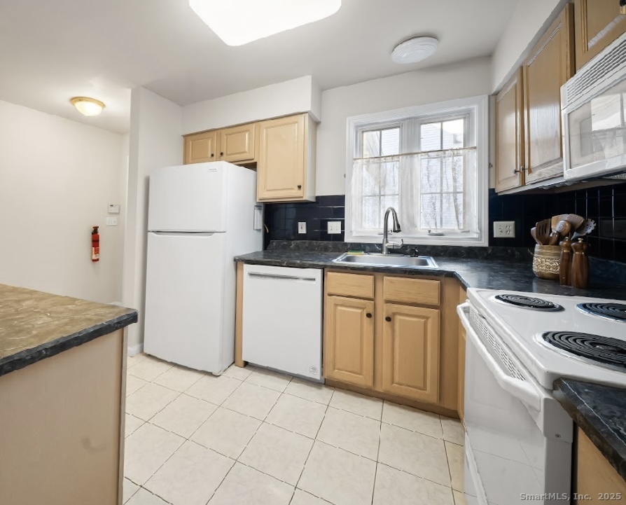 91 Forest Road, Unit B Milford, CT 06461 - Photo 14 of 28 a kitchen with a sink a stove and refrigerator
