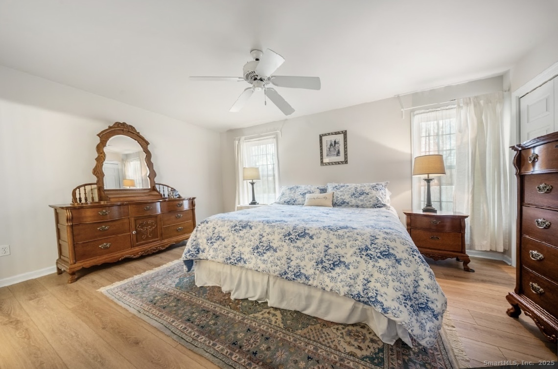 91 Forest Road, Unit B Milford, CT 06461 - Photo 17 of 28 a bedroom with a bed and a dresser with the wooden floor