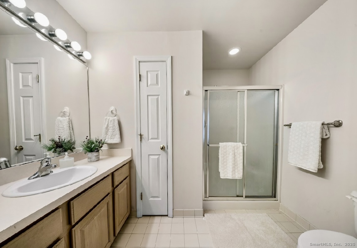 91 Forest Road, Unit B Milford, CT 06461 - Photo 19 of 28 a bathroom with a double vanity sink mirror and shower