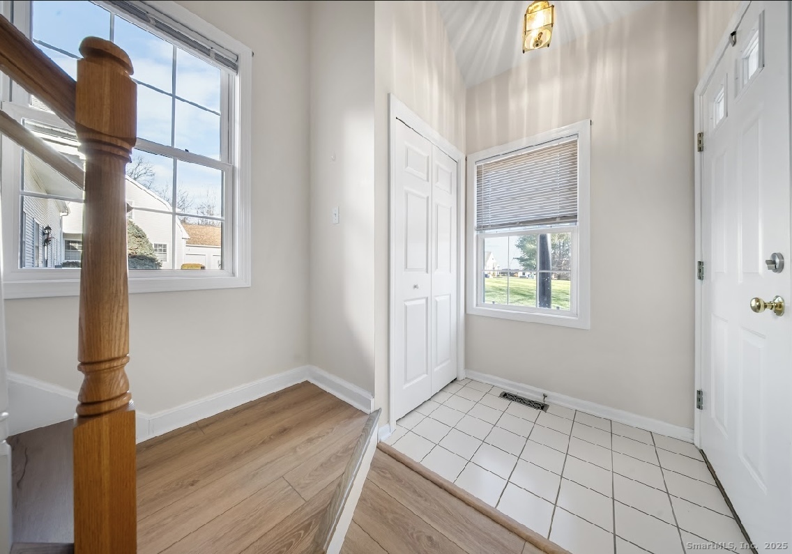 91 Forest Road, Unit B Milford, CT 06461 - Photo 26 of 28 a view of an empty room with a window and wooden floor