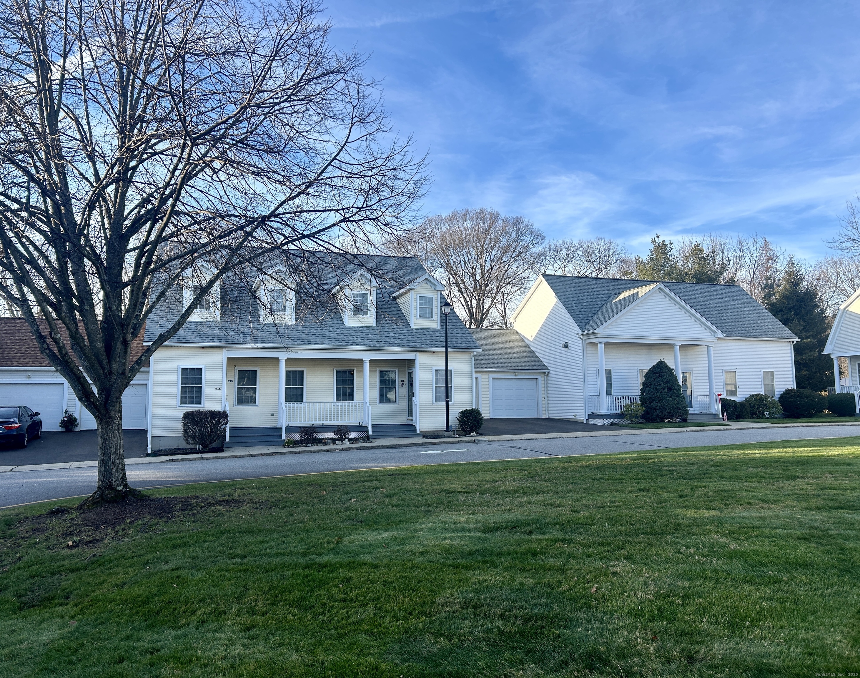 91 Forest Road, Unit B Milford, CT 06461 - Photo 3 of 28 a front view of a house with a garden and trees