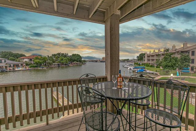 a balcony view with couple of chairs and couch