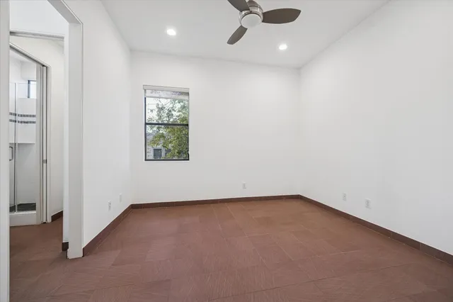 a bathroom with a granite countertop sink two mirror and shower