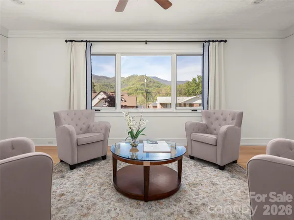 a living room with furniture and a large window