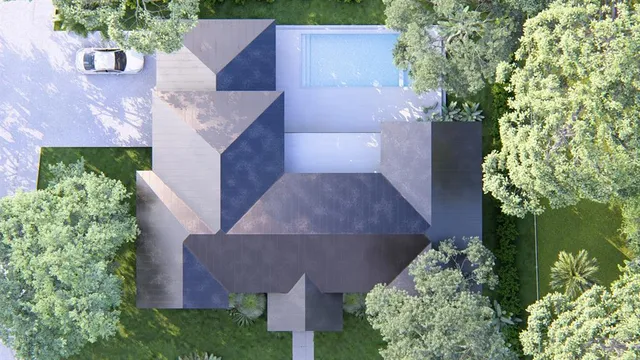 an aerial view of a house with a yard and garden