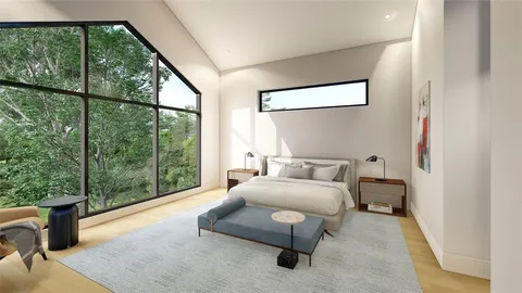 a bedroom with a bed and large window