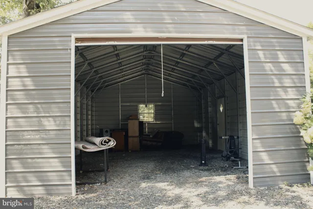 a view of a porch with a table and chairs and potted plants