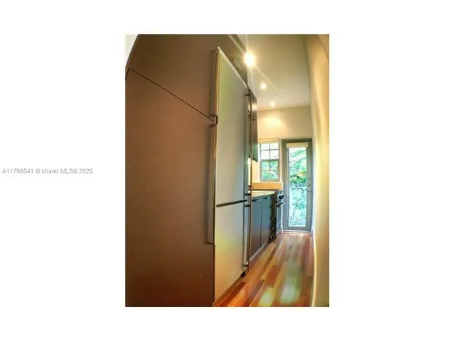 a open kitchen with a sink and a refrigerator