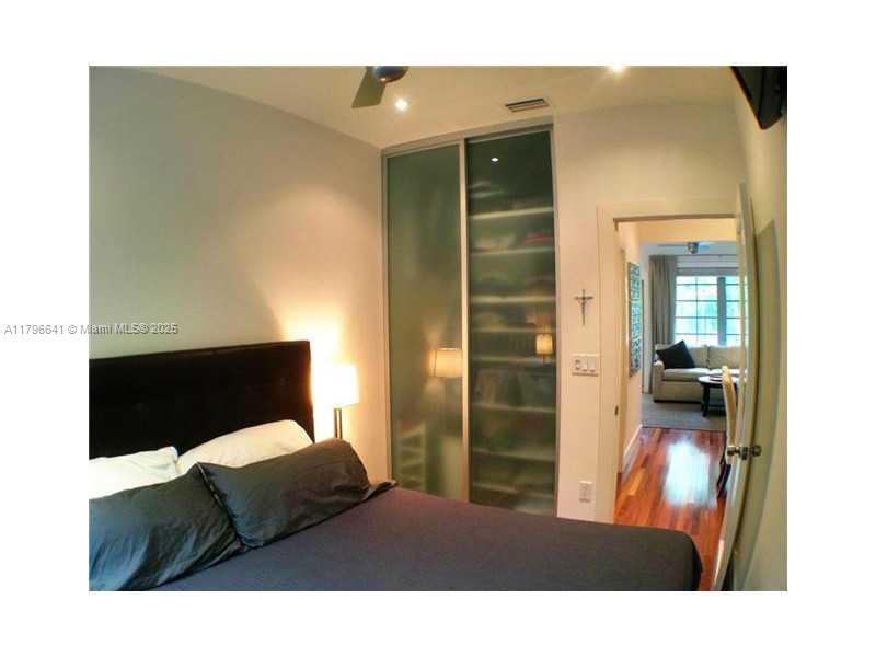 727 Jefferson Avenue, Unit 3 Miami Beach, FL 33139 - Photo 15 of 25 a living room with a bed furniture and a large window