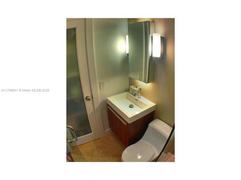 727 Jefferson Avenue, Unit 3 Miami Beach, FL 33139 - Photo 17 of 25 a living room with a couch and a table