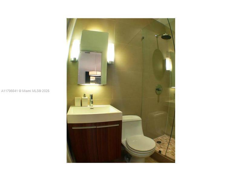 727 Jefferson Avenue, Unit 3 Miami Beach, FL 33139 - Photo 18 of 25 a bathroom with a sink a toilet and mirror