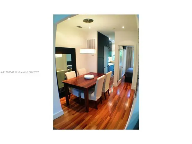 a living room with furniture and a dining table