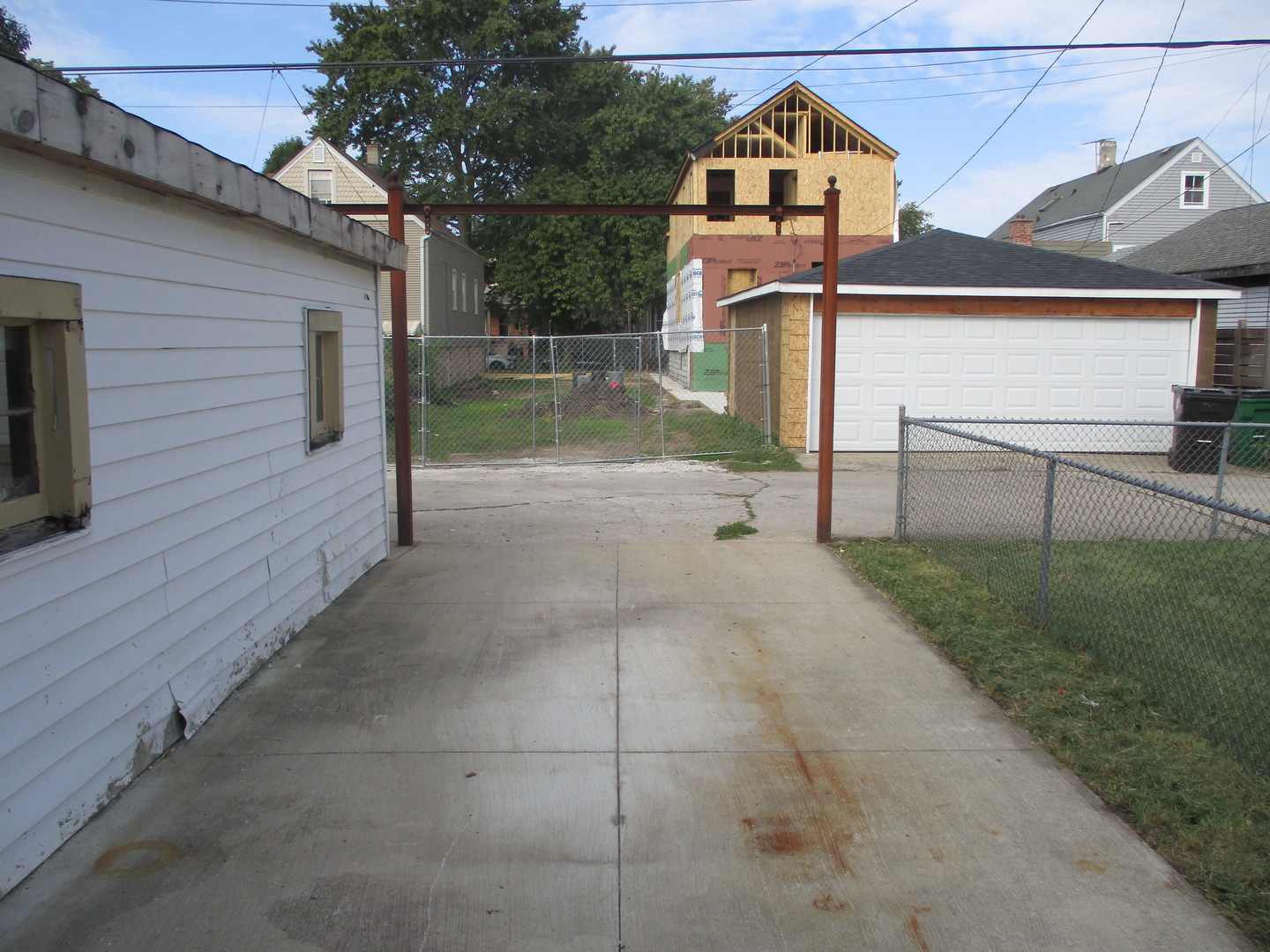 1324 Clinton Avenue Berwyn, IL 60402 - Photo 11 of 14 a view of a brick house with a small yard and wooden fence